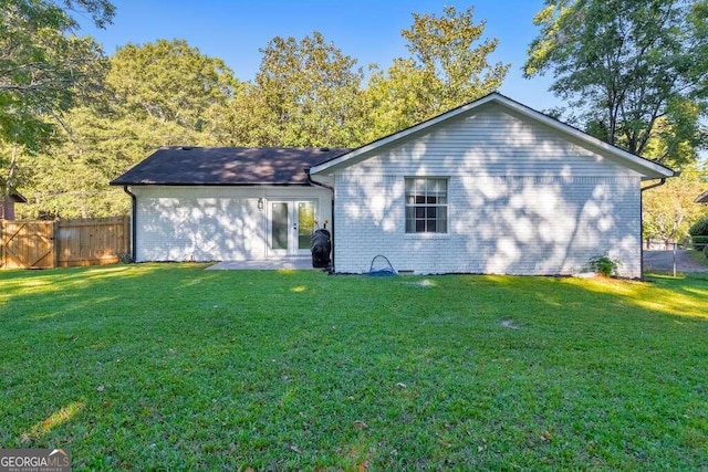 83 Sunset Ln, Newnan, GA 30263 - rear view of property with a yard, french doors, fence, and brick siding
