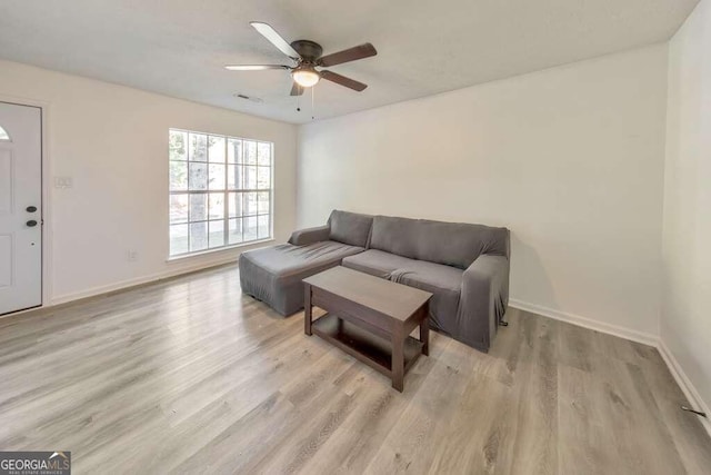 living room featuring ceiling fan and light hardwood / wood-style flooring