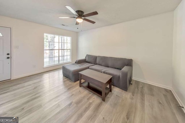 83 Sunset Ln, Newnan, GA 30263 - living room with light wood-style floors, baseboards, visible vents, and ceiling fan