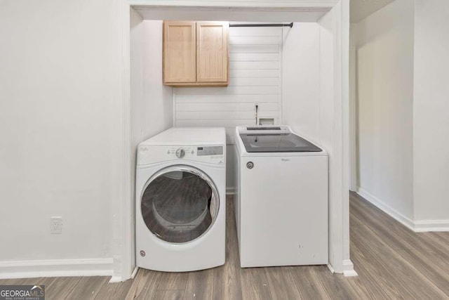 laundry area with washing machine and dryer and hardwood / wood-style floors