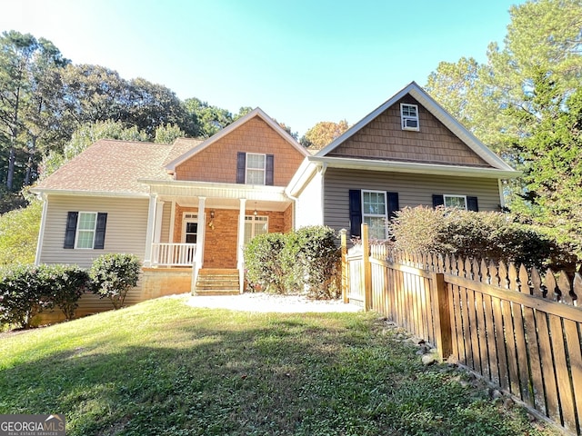 view of front of home featuring a front yard and a porch