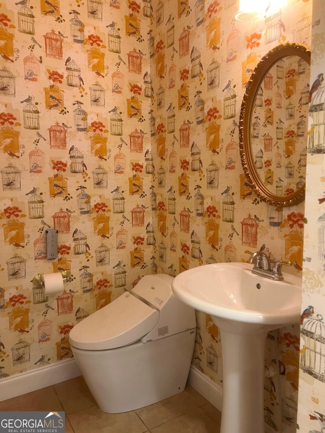 bathroom featuring toilet and tile patterned flooring