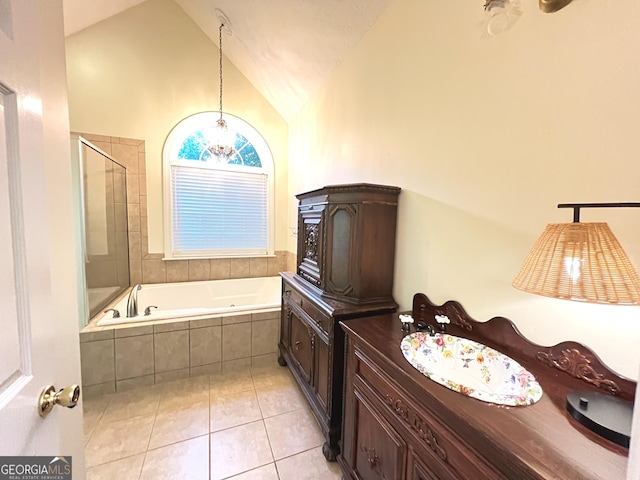 bathroom featuring vaulted ceiling, separate shower and tub, tile patterned floors, and vanity