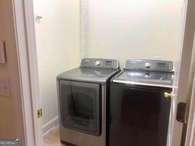 clothes washing area featuring washer and clothes dryer