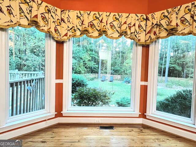 interior space featuring hardwood / wood-style flooring and a healthy amount of sunlight