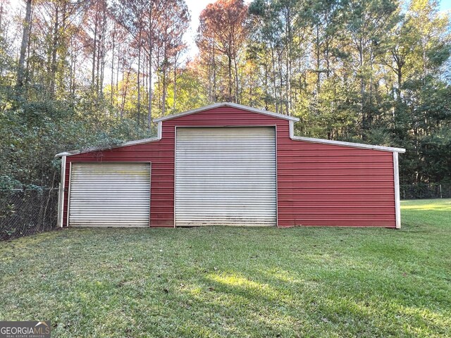 garage featuring a lawn