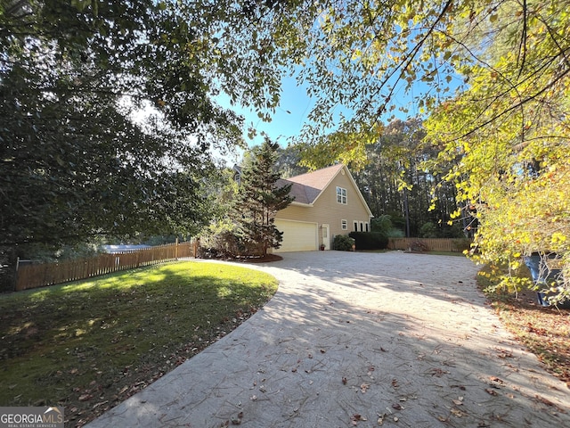 view of property exterior with a garage and a lawn