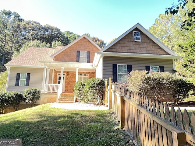 view of front facade with a front yard and a porch