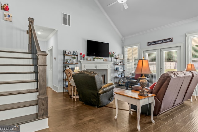 living room with high vaulted ceiling, crown molding, dark wood-type flooring, and french doors