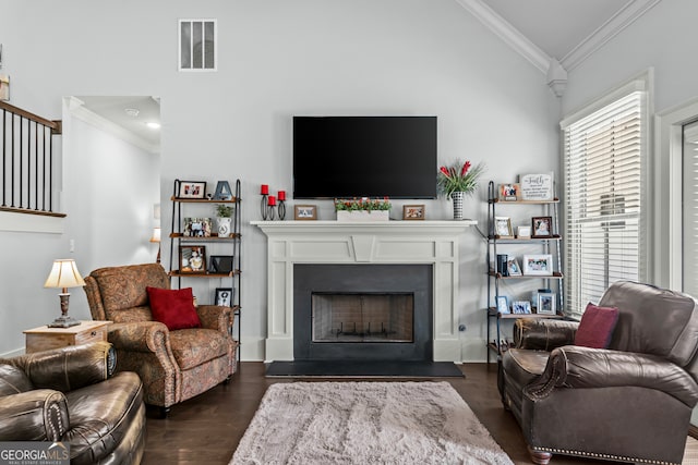 living room with crown molding, vaulted ceiling, and dark hardwood / wood-style flooring