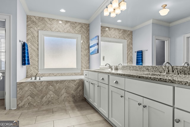 bathroom with ornamental molding, a tub to relax in, vanity, and tile walls