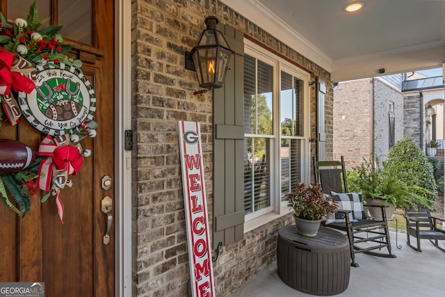 view of exterior entry featuring covered porch