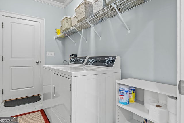 clothes washing area with light tile patterned floors, ornamental molding, and washer and dryer