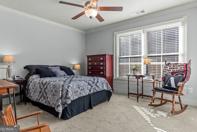 carpeted bedroom featuring ornamental molding and ceiling fan