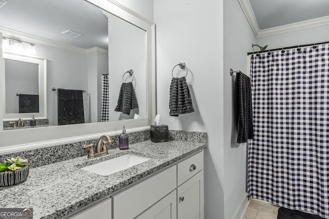 bathroom featuring tile patterned floors, crown molding, and vanity