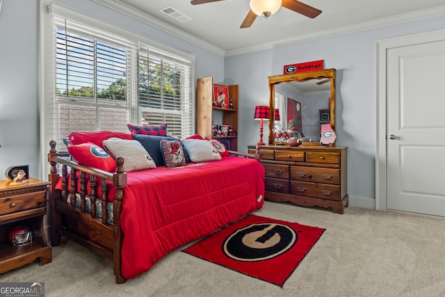 bedroom featuring crown molding, ceiling fan, and light colored carpet