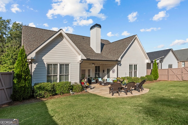 rear view of property with ceiling fan, a lawn, and a patio area