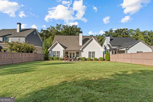 back of property featuring a lawn