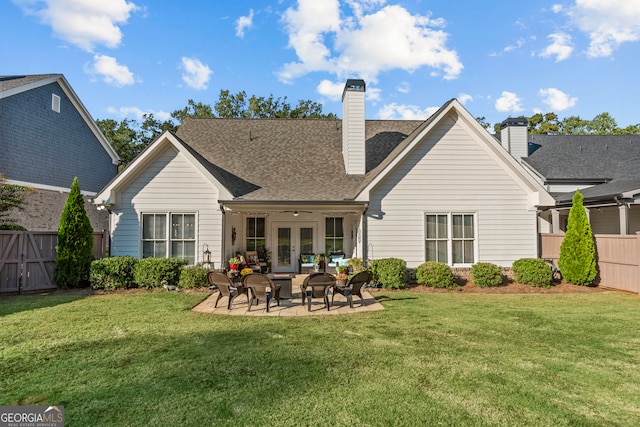 back of property featuring a lawn and a patio