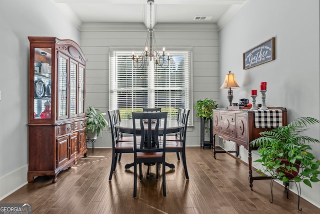 dining area with a chandelier, crown molding, dark hardwood / wood-style flooring, and a wealth of natural light