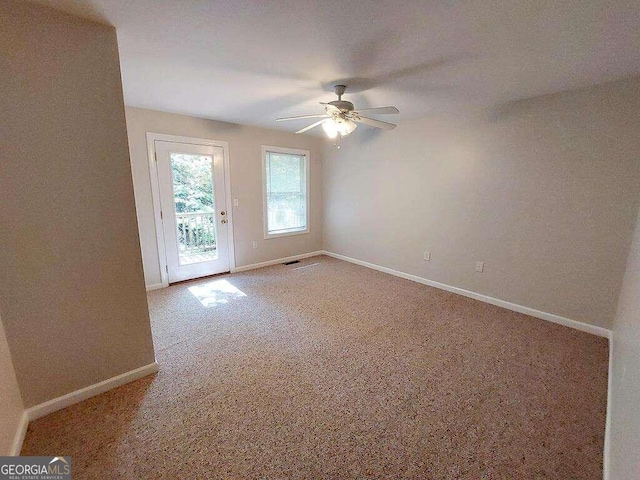 carpeted empty room featuring ceiling fan