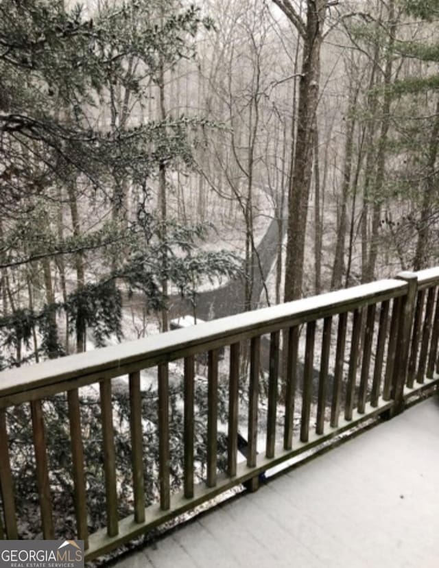 view of snow covered back of property