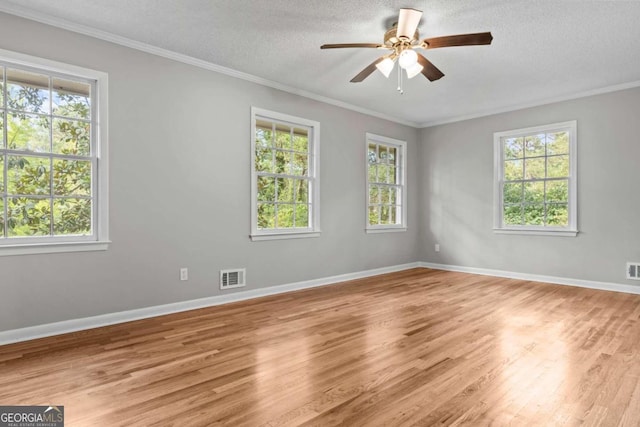 spare room featuring ornamental molding, ceiling fan, light hardwood / wood-style floors, and a textured ceiling