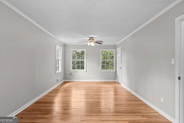 unfurnished room featuring a textured ceiling, crown molding, ceiling fan, and light hardwood / wood-style flooring