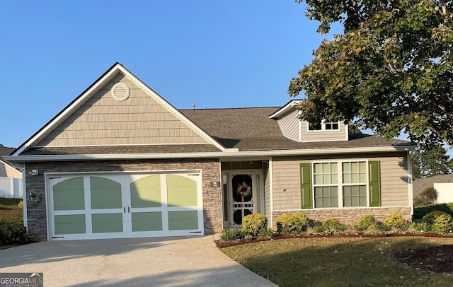 view of front of house with a front yard and a garage