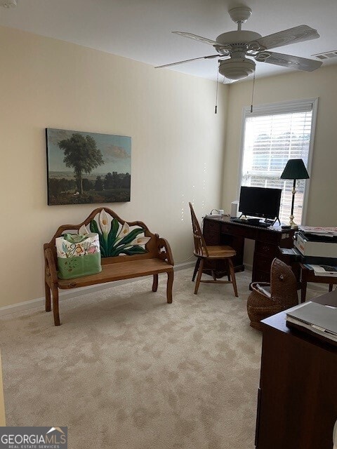 office area with ceiling fan and light carpet