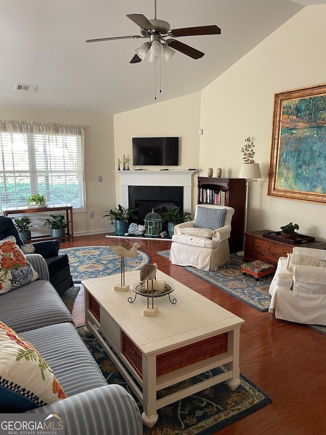 living room featuring ceiling fan, vaulted ceiling, and dark hardwood / wood-style flooring