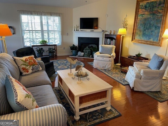 living room with vaulted ceiling and hardwood / wood-style floors