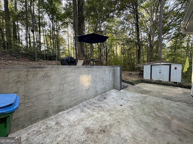 view of patio / terrace featuring a storage shed