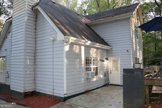 view of home's exterior with a patio and cooling unit