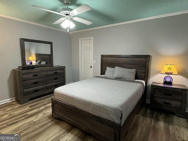 bedroom with a textured ceiling, hardwood / wood-style flooring, ceiling fan, and crown molding