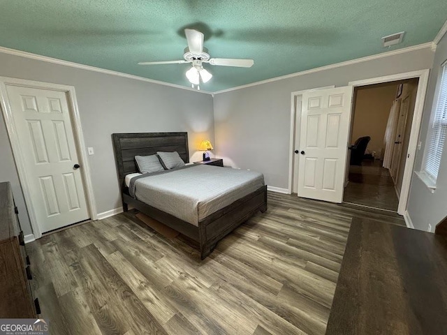 bedroom featuring hardwood / wood-style floors, ceiling fan, and crown molding