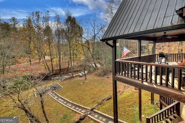 view of yard featuring ceiling fan and a wooden deck