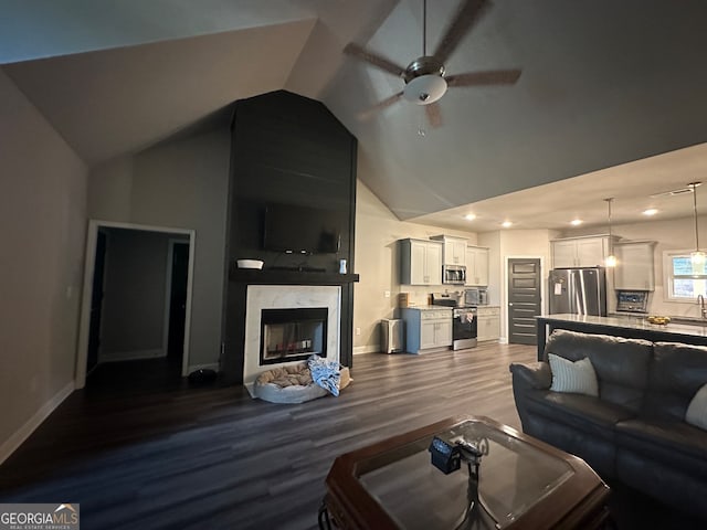 living room with ceiling fan, high vaulted ceiling, a high end fireplace, and hardwood / wood-style floors