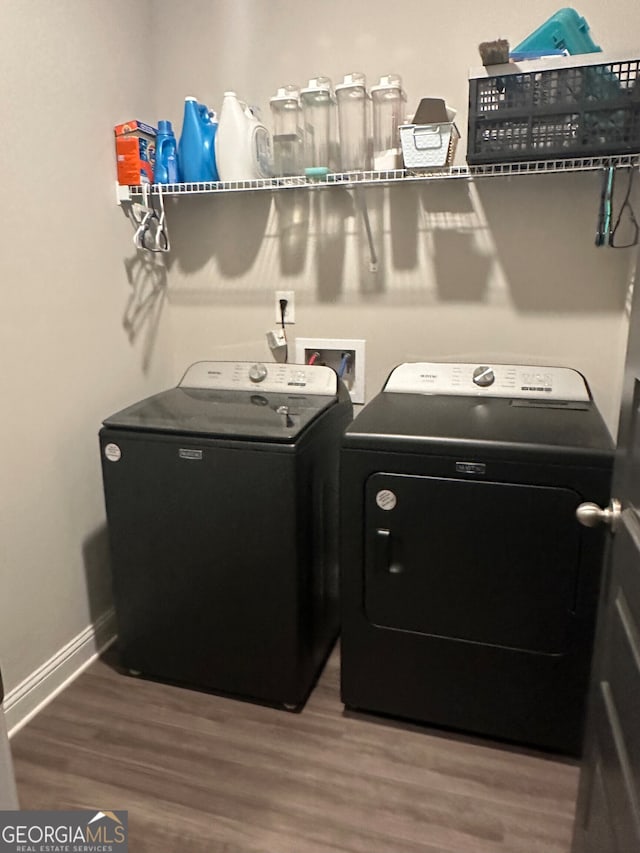 washroom featuring independent washer and dryer and hardwood / wood-style flooring