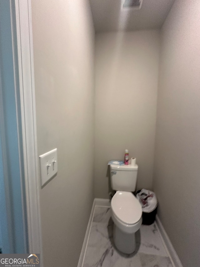 bathroom featuring a textured ceiling and toilet