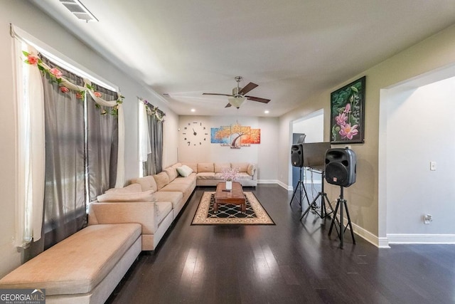 living room with dark hardwood / wood-style floors and ceiling fan