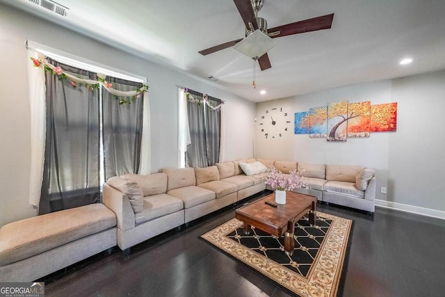 living room featuring dark hardwood / wood-style flooring and ceiling fan