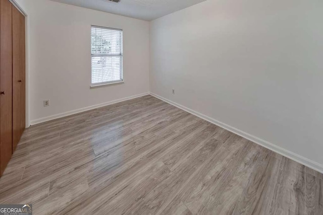 unfurnished room featuring light hardwood / wood-style flooring