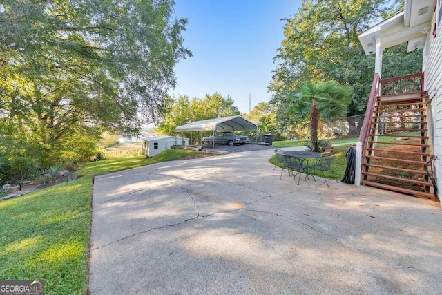 exterior space with a carport and a lawn