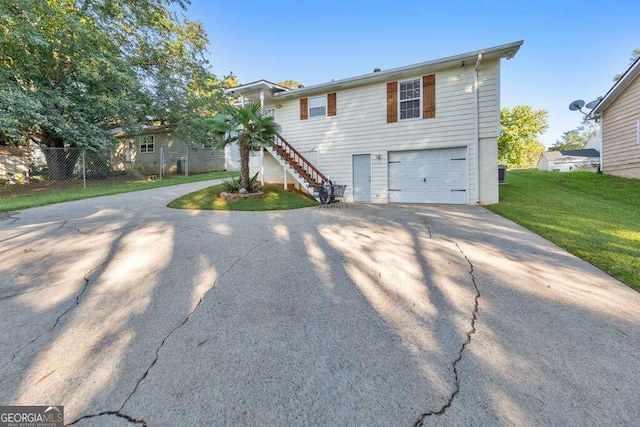 view of front of house with a front yard and a garage