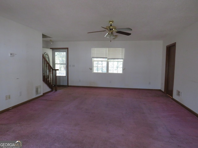 402 Thurman Rd, Stockbridge, GA 30281 - empty room featuring a ceiling fan, carpet floors, stairway, and baseboards