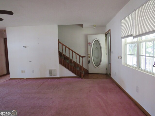 foyer featuring ceiling fan, washer / clothes dryer, and light colored carpet