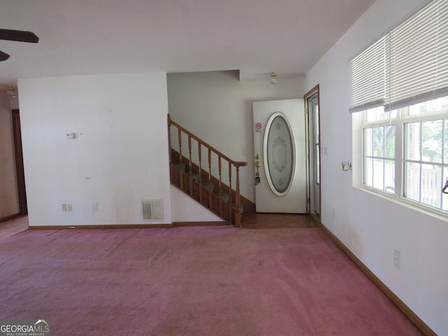 402 Thurman Rd, Stockbridge, GA 30281 - foyer entrance featuring carpet, stairway, a ceiling fan, and baseboards