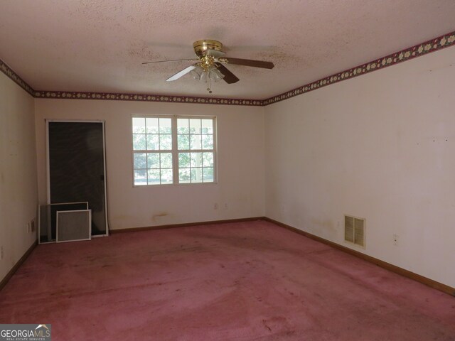 unfurnished room with ceiling fan, a textured ceiling, and carpet flooring