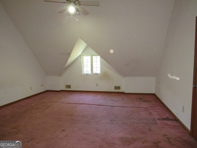 additional living space featuring ceiling fan, carpet floors, and vaulted ceiling